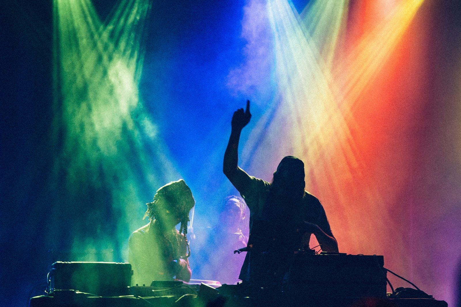 silhouette of dj playing with colored lights After Party Dubai